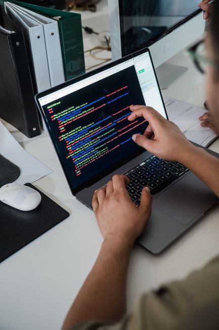 Developer debugging code on laptop