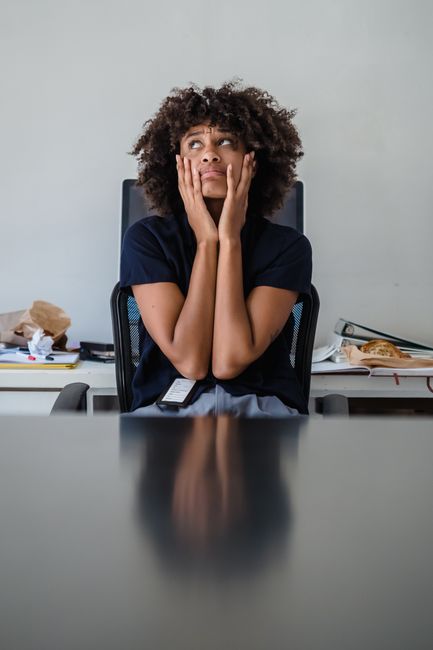 An illustration of a person stressed out by a long to-do list, symbolizing the anxiety of over-control.